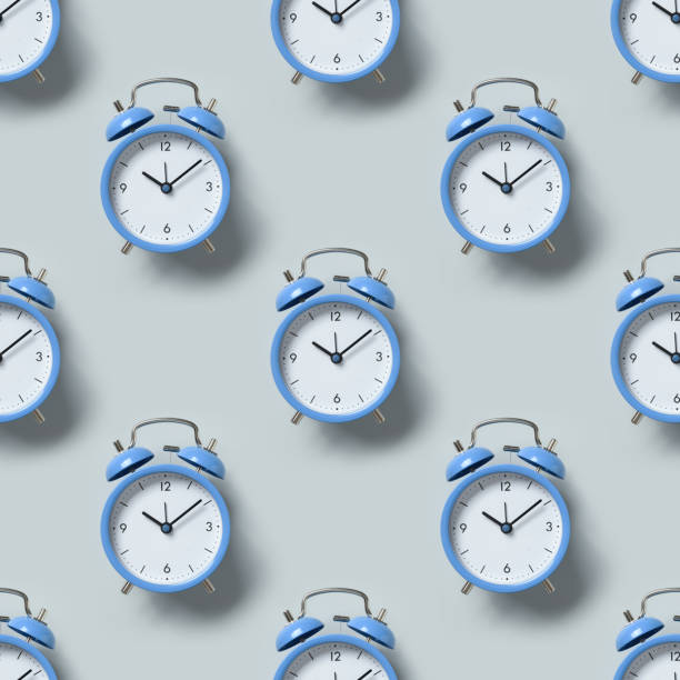 istock Seamless pattern of old-fashioned blue alarm clocks. 1414234756