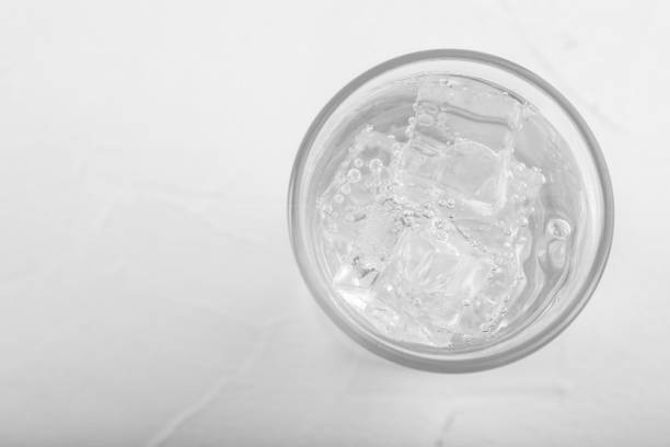 istock Glass of soda water on white table, top view. Space for text 1414235307