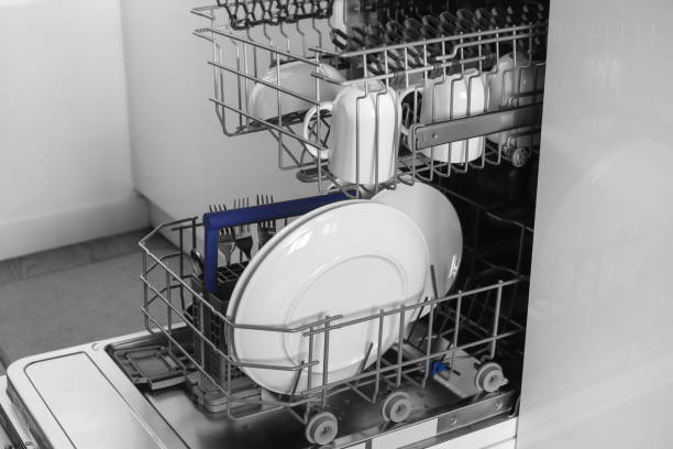 istock Dishwasher. Loading dishes. Dishwashing capsules. Open dishwasher with clean dishes in the white kitchen. Opening and closing the dishwasher. 1414236889