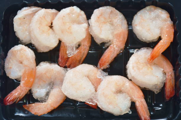 raw shrimp food ingredient arranging on plastic tray stock photo
