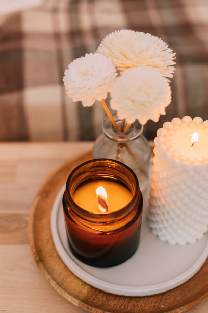 istock Home aroma fragrance diffuser and burning candles with wooden wick. Interior elements. 1414237629