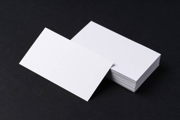 istock White blank business cards on dark black background 1414240249