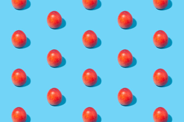 istock Ripe nectarines are laid out in even rows on a blue background. 1414240657