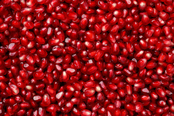 istock Tasty pomegranate seeds as background, top view 1414242207