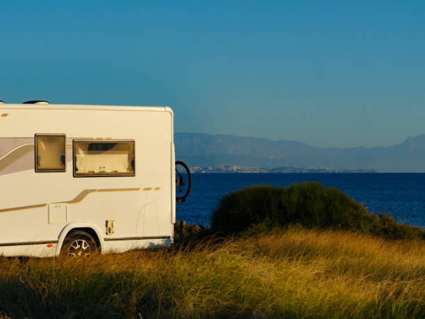 istock Camper car on beach sea shore 1414242438
