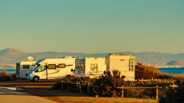 istock Camper cars on beach sea shore 1414242617