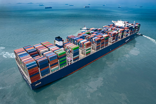 Aerial view of a fully loaded container ship in the blue sea