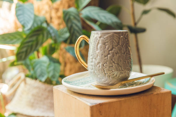 istock Gray ceramic mug in room decorated with plants. 1414244289