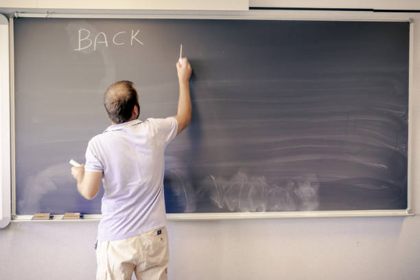 Teacher in a teenagers classroom.