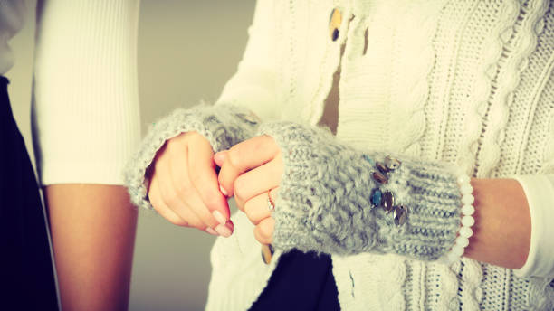 istock Sensitive female hands with gray gloves. 1414246118