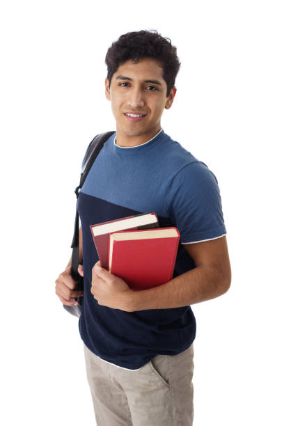 istock Male student holding backpack and books and smiling at camera 1414247843