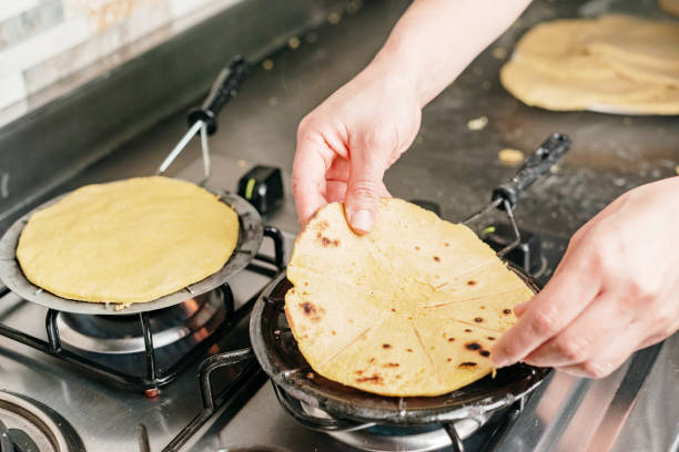 istock Hands placing a corn arepa on a grill 1414249328