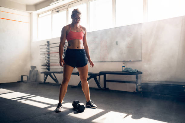 istock Active woman, having an weightlifting workout at the gym 1414249330