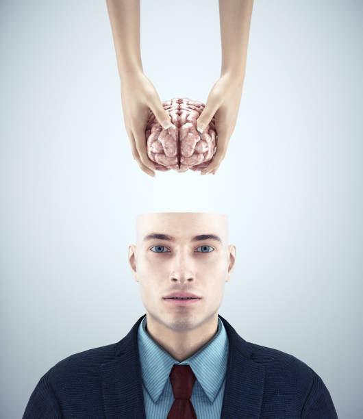 istock Half head man receiving a brain. Mental health and mindset change concept. 1414250106