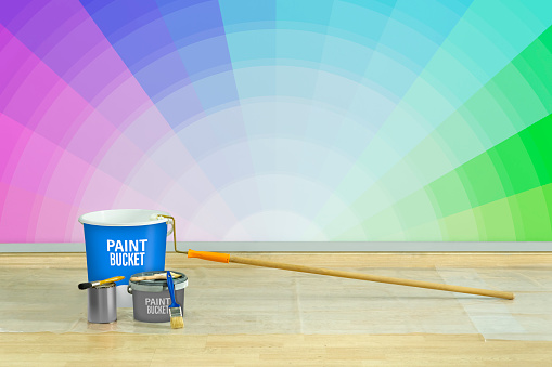 close-up image of paint brushes, roller, paint can, and paint samples