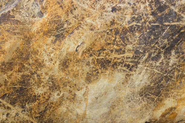 istock Natural stone background with golden veins. Granite slab stone, rustic matt texture 1414250856