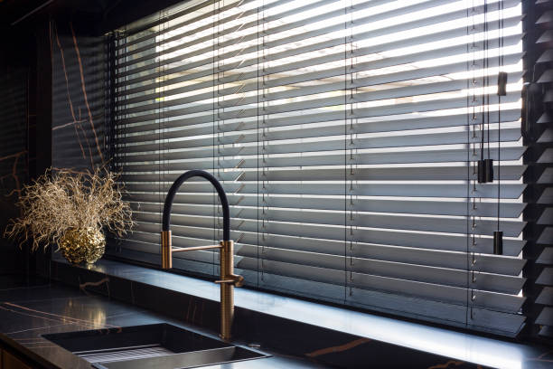 istock Wooden blinds black color closeup on the window. 1414252241