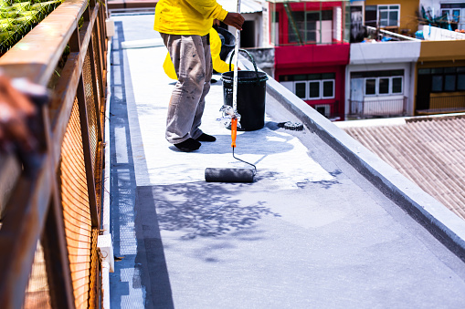 Painted gray flooring on fiber glass with paint rollers for waterproof, reinforcing net, Repairing waterproofing deck flooring.
