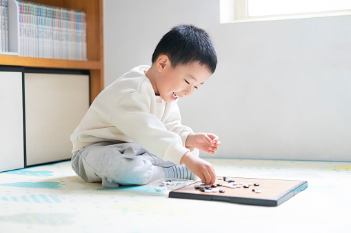 A Chinese baby playing chess
