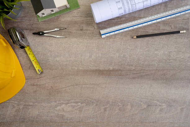 istock Flat lay of top view desk work table Engineer with Blueprint drawing,Yellow Helmet,architect design stationary and house model mock up in Engineer Architect concept includes copyspace for add text or graphic 1414257443