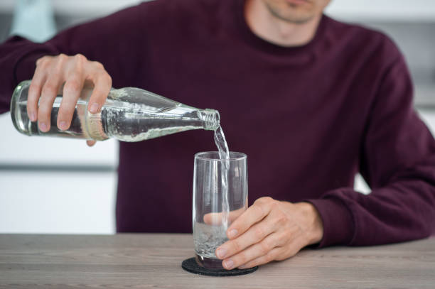 istock Man pouring water in glass 1414258905