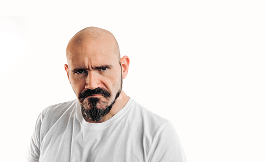 Annoyed man. Person with bad face on white background. Expressive man with beard and mustache.