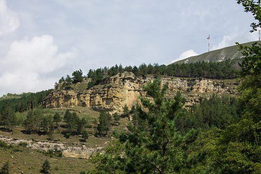 Beautiful landscape with steep cliffs and green trees on a sunny summer day in the vicinity of Kislovodsk