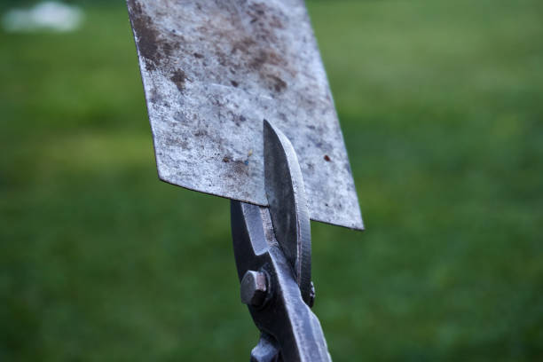 istock Scissors cutting a thick piece of sheet metal. Metal scissors, hand tools close-up. Selective soft selective focus 1414261469