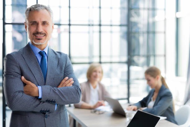 istock Businessman with colleagues in the background in office. 1414263726