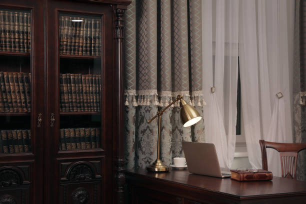 istock Library reading room interior with wooden bookcase and table near window 1414263839