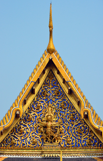 Bangkok, Thailand: Wat Phra Kaew / Temple of the Emerald Buddha, national shrine for the monarchy and the state - ordination hall (Phra Ubosot), tympanum with the god Narayana on the back of a Garuda, 'chofa' ornament at the top,