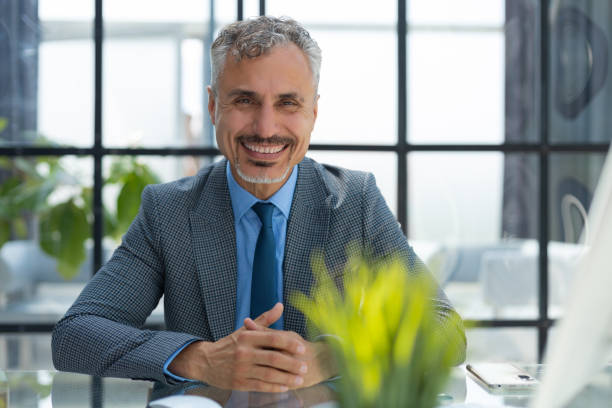 istock Mature businessman working on computer in modern office. 1414265113