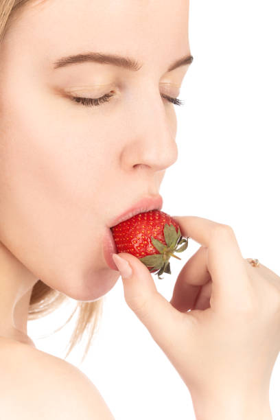 istock girl with strawberry 1414267279