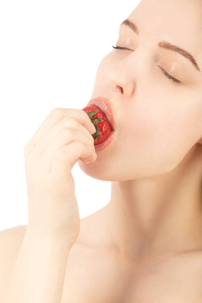 istock girl with strawberry 1414267396