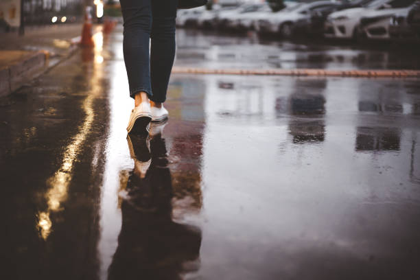 Unrecognizable woman walking in the rain.