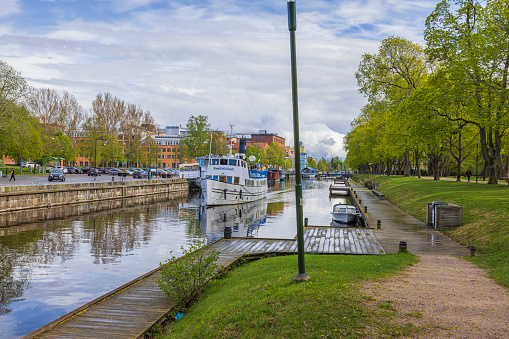 Sweden. Uppsala. 05.14.2022. View of white tourist excursion boat on cityscape background.