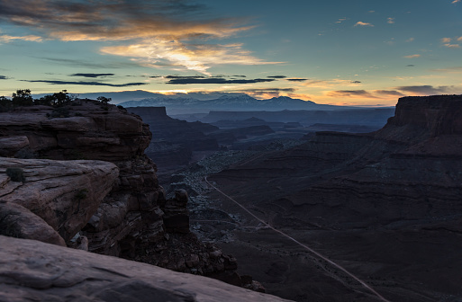 Time lapse of Canyonlands National Park in Utah,  looking down on Shafer Canyon in the Island in the Sky district. The famous Shafer Canyon Trail is visible on the valley floor down below, and in the distance are the snowcapped peaks of the La Sal Mountains. This image is part of a series of views taken at different times of day from the same location; a time lapse is also available.