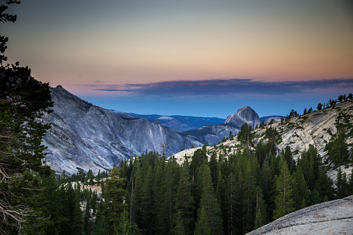 Stunning view of Yosemite Valley from Olmstead Point at sunrise on a summer morning, with Half Dome in the distance. This still image is part of a series taken at different times of day from the same location; a time lapse is also available.