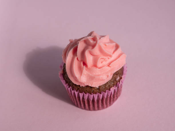 istock Cupcake on a purple background with side lighting and a place for text 1414277179