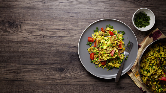 Homemade scrambled tofu with peas, mushroom, serve on toasted ciabatta bread and cherry tomato and fine chopped coriander.