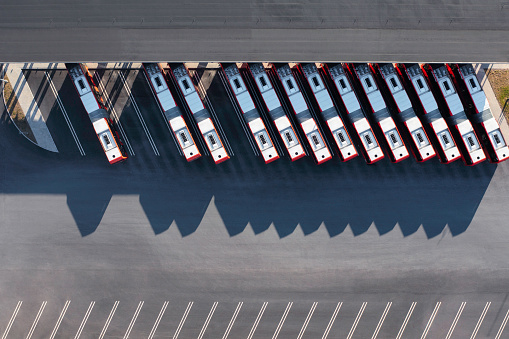Electric buses in a parking lot when not on public transportation service.