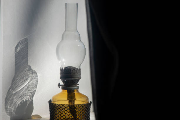 Delicate tulle on the windowsill and a kerosene lamp.