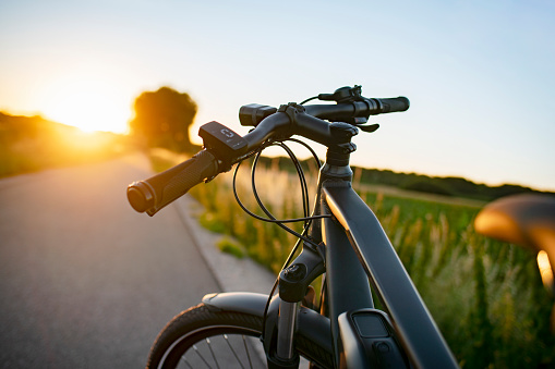 E-bike on the country road at sunset