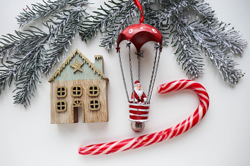 christmas card. Christmas tree, a small house and a figurine of Santa Claus