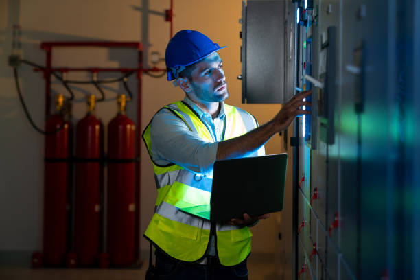 istock Electrical engineer use laptop to inspection and testing of electrical system in control room. 1414286049