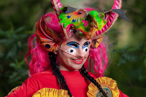 Ecuadorian Latina woman with devil mask, getting ready for the Diablada Pillareña parade, close up shot.