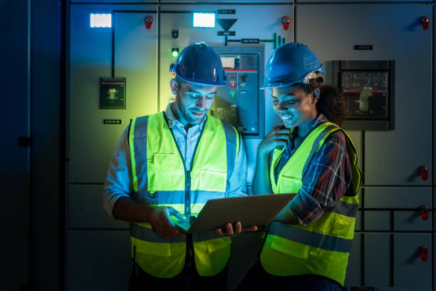 electrical engineer use laptop to inspection and testing of electrical system in control room. - power line electricity construction fuel and power generation imagens e fotografias de stock