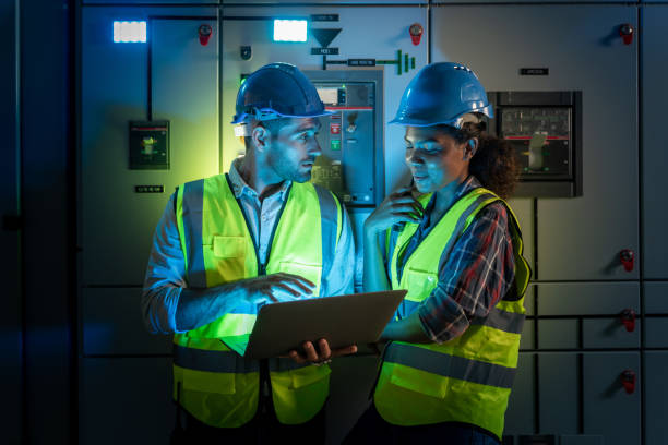 electrical engineer use laptop to inspection and testing of electrical system in control room. - power line electricity construction fuel and power generation imagens e fotografias de stock