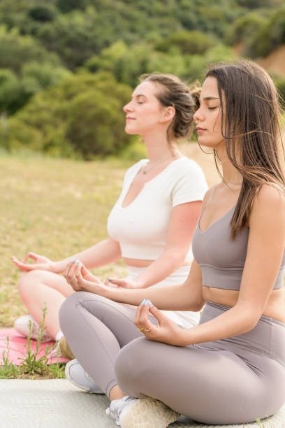 istock Two Girls Meditating Outside 1414286156