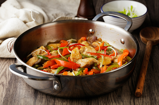 Homemade chicken with pepper stir-fry and serve with spring onion